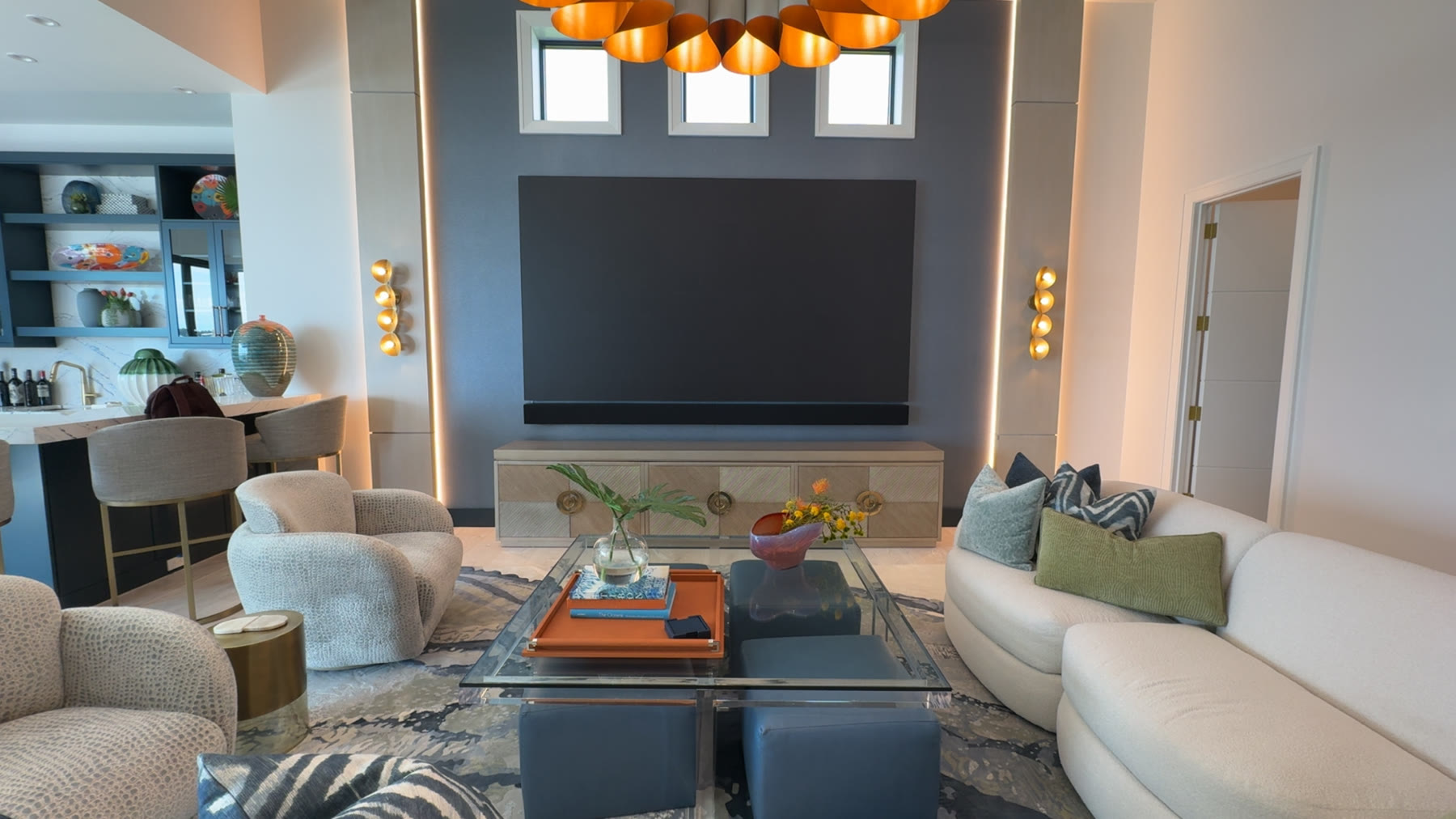 Wide residential room view showing a custom soundbar aligned below a direct-view video wall